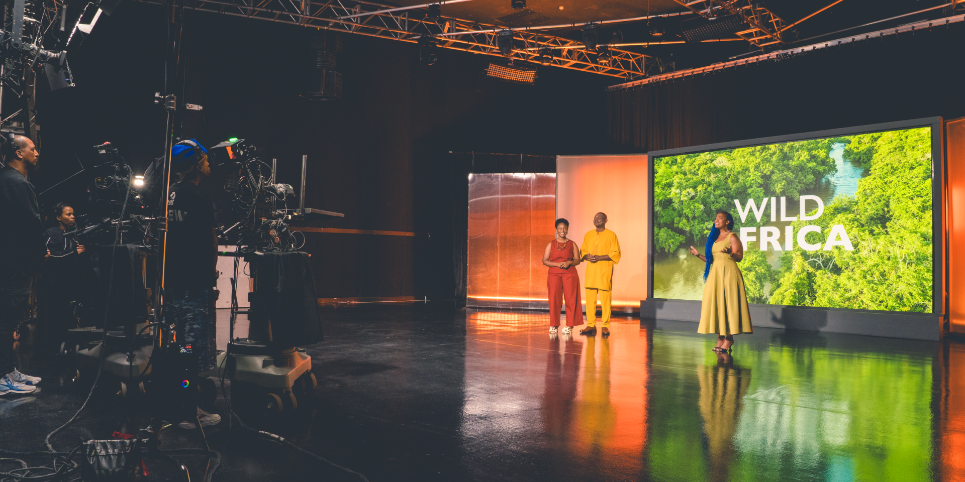 The Wild Africa presenters standing in studio.